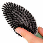 Gros plan sur la face brosse à fibres souples d’une brosse pour chien et chat montrant la flexibilité des poils pour un brossage doux